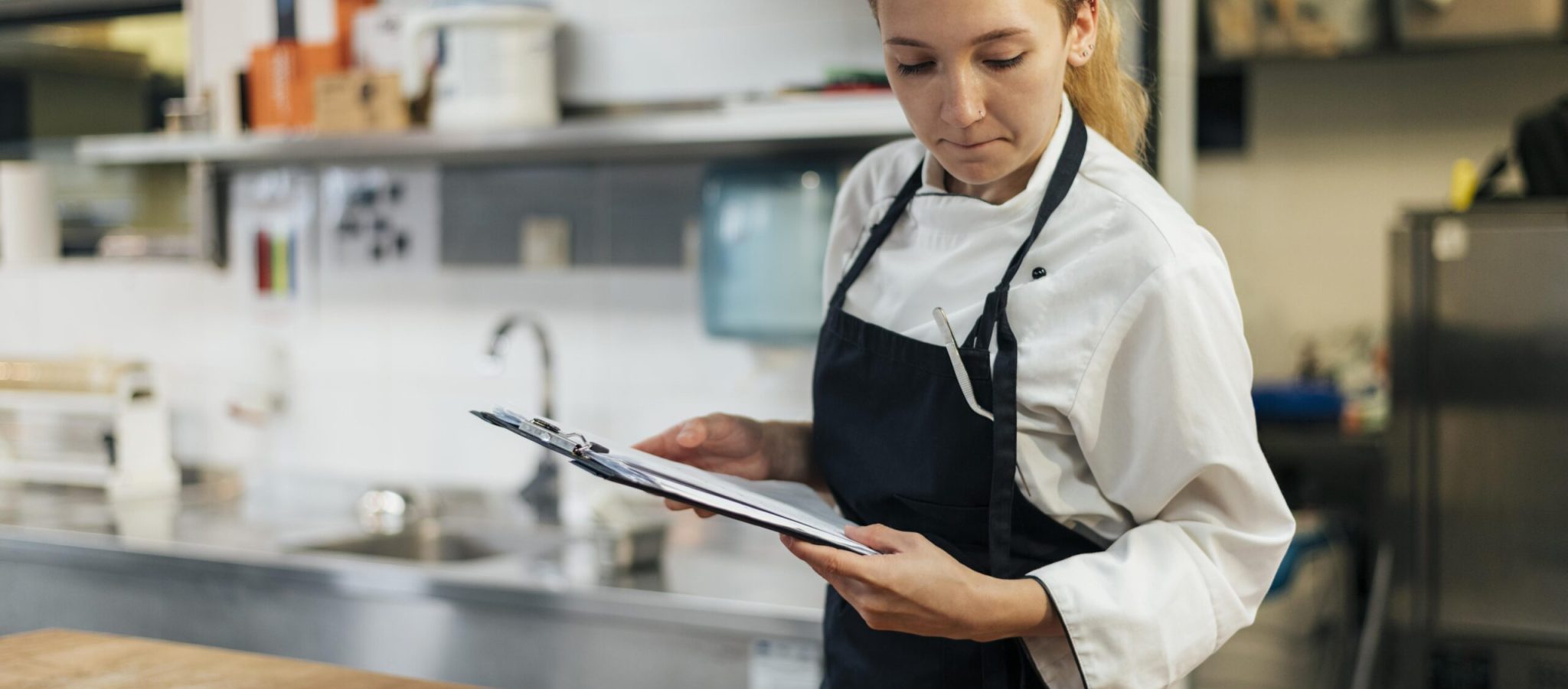 female-chef-with-clipboard-checking-her-tools